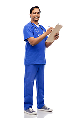 Image showing male doctor writing medical report on clipboard