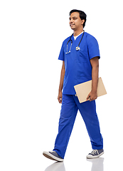 Image showing male doctor walking with clipboard and stethoscope