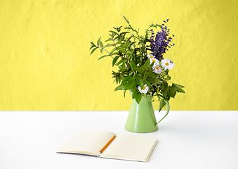 Image showing notebook with pencil and bunch of flowers in jug