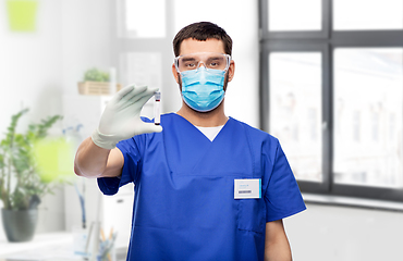 Image showing male doctor in mask with blood in test tube