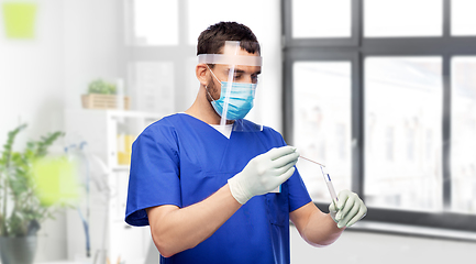 Image showing male doctor in mask with cotton swab and test tube