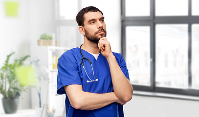 Image showing thinking doctor or male nurse with stethoscope