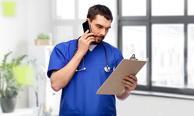 Image showing doctor or male nurse calling on smartphone