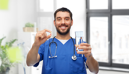 Image showing doctor or male nurse with medicine and water