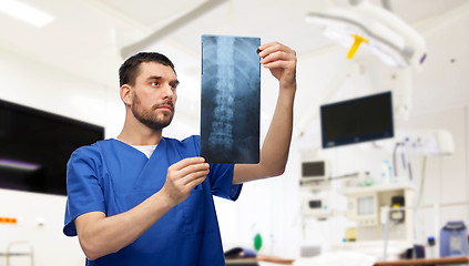 Image showing doctor or male nurse looking at x-ray scan