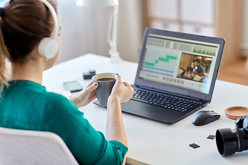 Image showing woman with video editor program on laptop at home