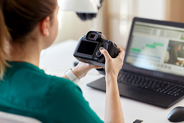 Image showing woman with camera and video editor on laptop