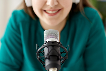 Image showing woman with microphone recording podcast at studio