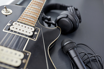 Image showing close up of bass guitar, microphone and headphones