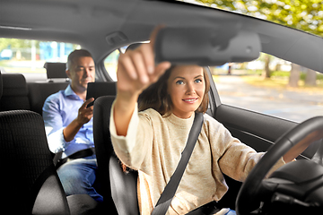 Image showing female driver driving car with male passenger