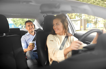 Image showing female driver driving car with male passenger