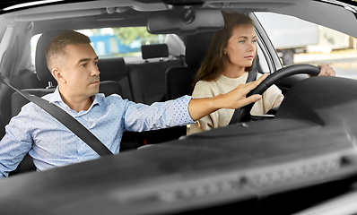 Image showing car driving school instructor teaching woman