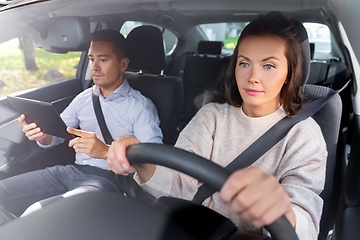 Image showing woman and driving school instructor in car