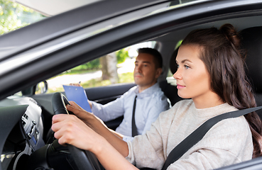 Image showing car driving school instructor and young driver