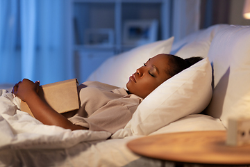 Image showing african woman sleeping in bed at home at night