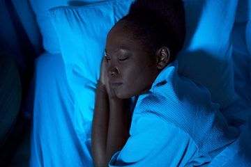 Image showing african woman sleeping in bed at home at night