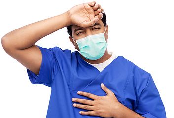 Image showing tired indian male doctor in blue uniform and mask