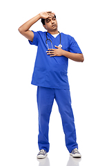 Image showing stressed doctor or male nurse in blue uniform