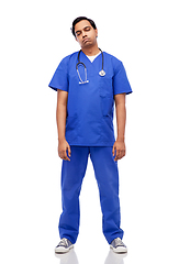 Image showing tired indian doctor or male nurse in blue uniform