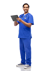 Image showing smiling doctor or male nurse using tablet computer