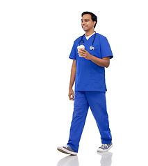 Image showing male doctor walking with coffee and stethoscope