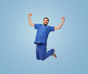 Image showing happy smiling doctor or male nurse jumping in air