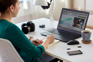 Image showing woman with video editor program on laptop at home