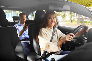 Image showing female driver driving car with male passenger