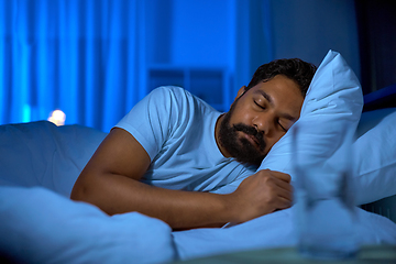 Image showing indian man sleeping in bed at home at night