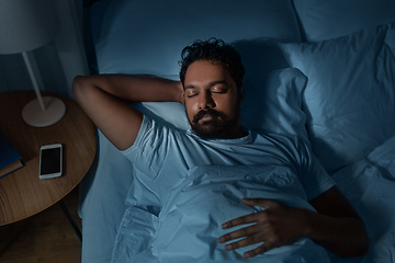 Image showing indian man sleeping in bed at home at night