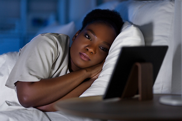 Image showing woman with tablet pc in bed at home at night