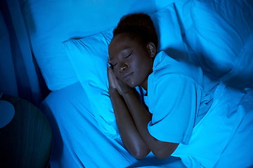 Image showing african woman sleeping in bed at home at night