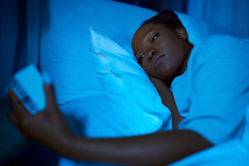 Image showing woman awaking because of alarm clock at night