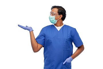 Image showing indian male doctor in mask holding something