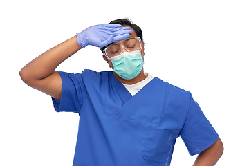 Image showing tired indian male doctor in blue uniform and mask