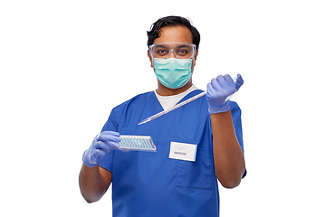 Image showing indian scientist in mask with dropper and vaccine