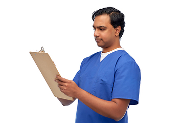 Image showing male doctor writing medical report on clipboard