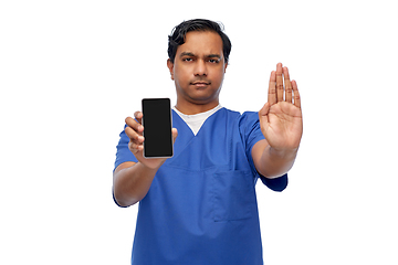 Image showing indian male doctor with phone showing stop gesture