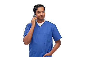 Image showing smiling doctor or male nurse calling on smartphone