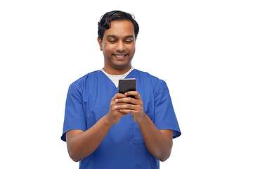 Image showing smiling doctor or male nurse using smartphone