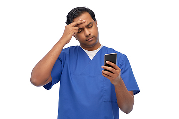 Image showing indian doctor or male nurse using smartphone