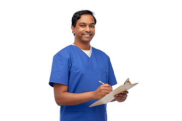 Image showing male doctor writing medical report on clipboard