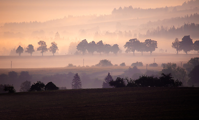 Image showing Autumn foggy and misty sunrise landscape