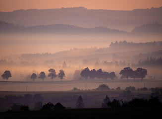 Image showing Autumn foggy and misty sunrise landscape