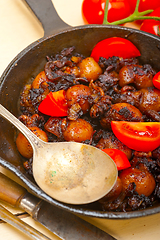 Image showing Baby cuttle fish roasted on iron skillet