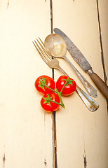 Image showing ripe cherry tomatoes over white wood