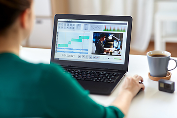 Image showing woman with video editor program on laptop at home