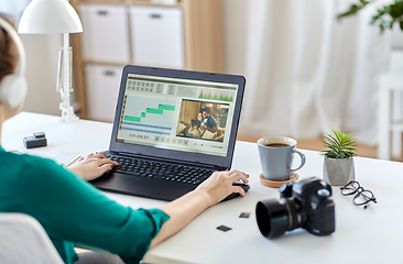 Image showing woman with video editor program on laptop at home