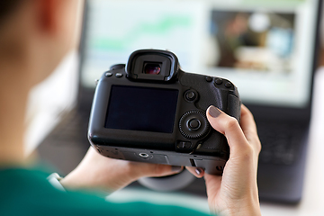 Image showing woman with camera and video editor on laptop