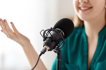 Image showing woman with microphone recording podcast at studio